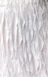 white ruffled skirt press piece